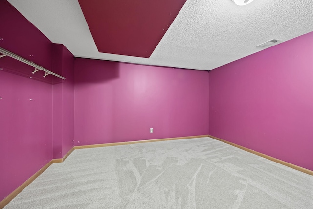 bonus room with a textured ceiling and carpet