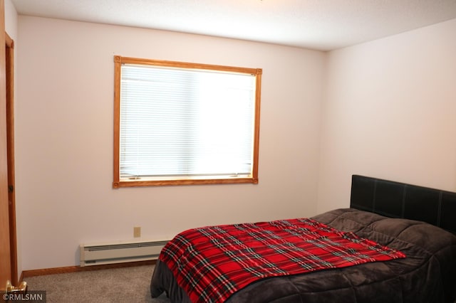 carpeted bedroom with a baseboard heating unit