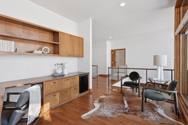 office featuring visible vents, recessed lighting, built in desk, and dark wood-style flooring