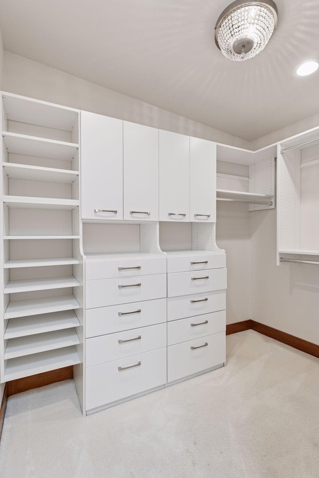 walk in closet featuring light carpet