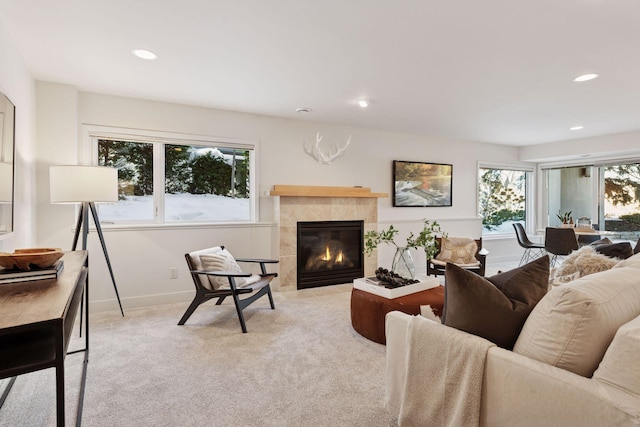 living area featuring recessed lighting, baseboards, carpet floors, and a tiled fireplace