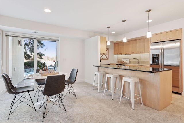 dining room featuring recessed lighting, baseboards, and light carpet