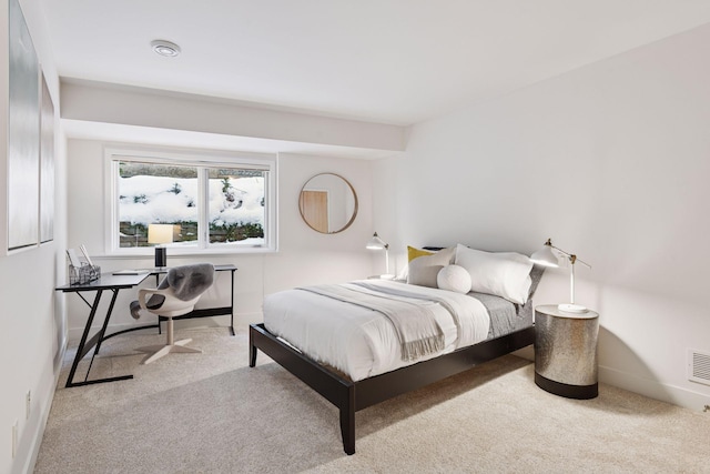 carpeted bedroom featuring visible vents and baseboards