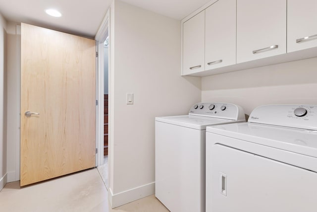 washroom with recessed lighting, cabinet space, baseboards, and washing machine and clothes dryer