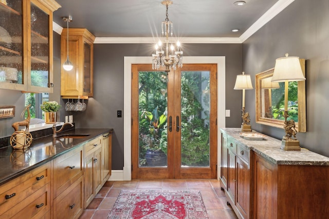 entryway with french doors, ornamental molding, an inviting chandelier, and sink