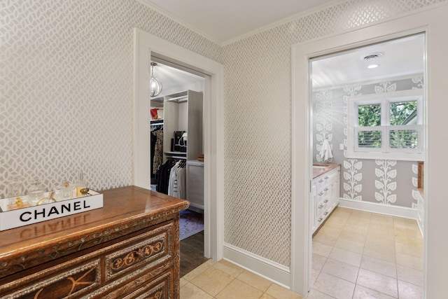 corridor with ornamental molding and light tile patterned flooring