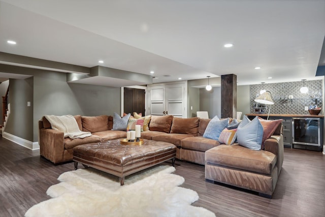 living room featuring dark hardwood / wood-style floors, bar area, and wine cooler