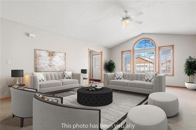 living area featuring baseboards, lofted ceiling, ceiling fan, a textured ceiling, and carpet flooring