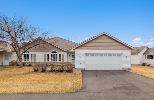 101 Bridgewater Trl, Hudson, WI 54016 - ranch-style house with driveway, a garage, and a front yard