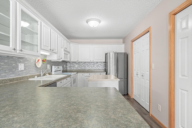 101 Bridgewater Trl, Hudson, WI 54016 - kitchen with white appliances, glass insert cabinets, white cabinetry, a sink, and a textured ceiling
