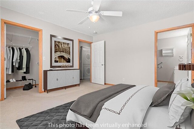 101 Bridgewater Trl, Hudson, WI 54016 - carpeted bedroom with estacked washer and dryer, baseboards, a closet, a textured ceiling, and ceiling fan