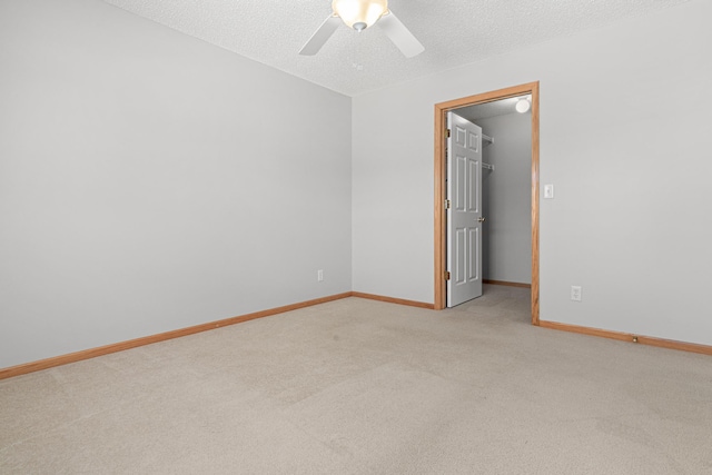 101 Bridgewater Trl, Hudson, WI 54016 - spare room featuring light carpet, a ceiling fan, baseboards, and a textured ceiling