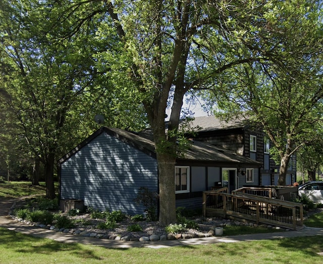 view of home's exterior with a wooden deck