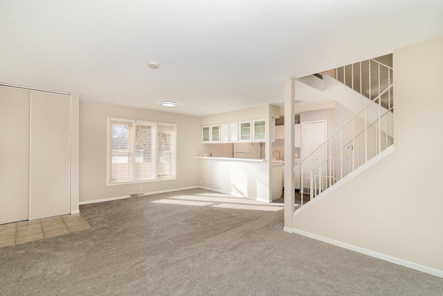 unfurnished living room with carpet flooring