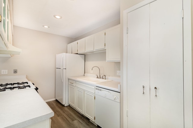 kitchen featuring dark hardwood / wood-style floors, range hood, sink, white cabinets, and white appliances