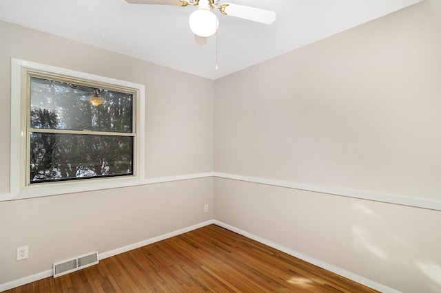 spare room featuring hardwood / wood-style flooring and ceiling fan