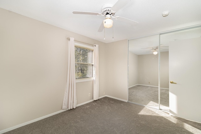 empty room featuring ceiling fan and carpet flooring