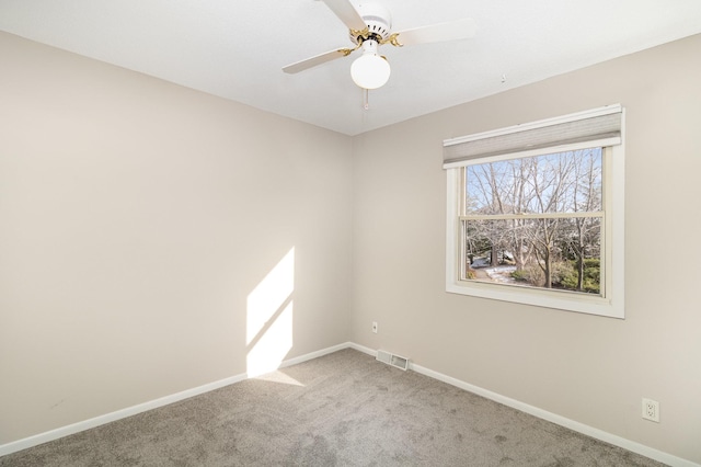 spare room featuring carpet floors and ceiling fan