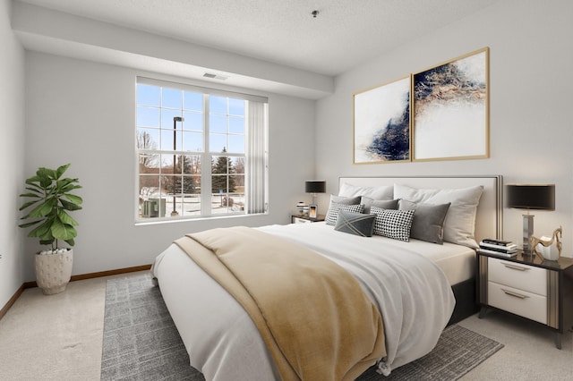 bedroom featuring carpet flooring and a textured ceiling