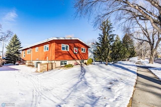 view of snowy exterior with central AC