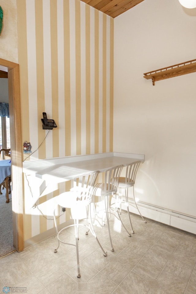 dining area featuring tile patterned flooring and a baseboard heating unit