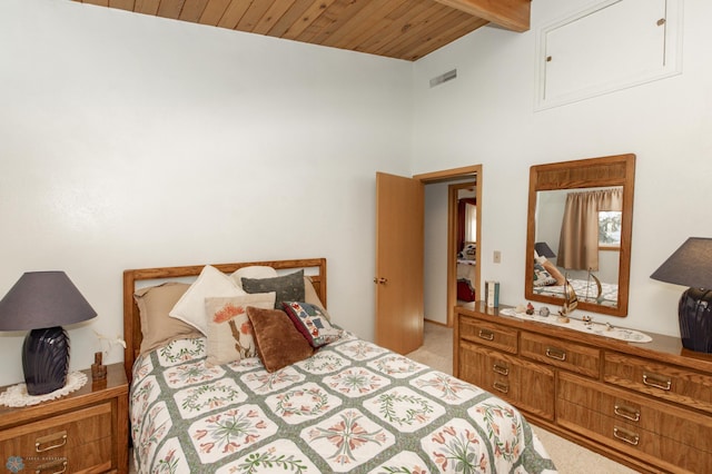 bedroom featuring vaulted ceiling with beams, light colored carpet, and wooden ceiling