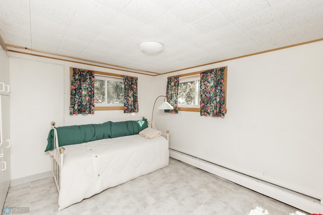 interior space with crown molding and a baseboard heating unit