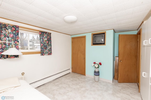 bedroom with a baseboard radiator and a closet