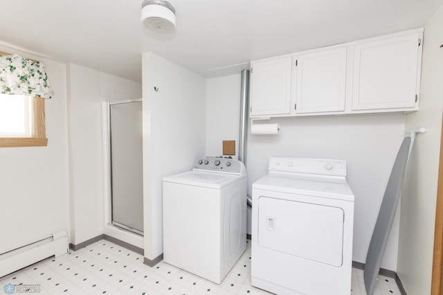 laundry room with separate washer and dryer, a baseboard radiator, and cabinets