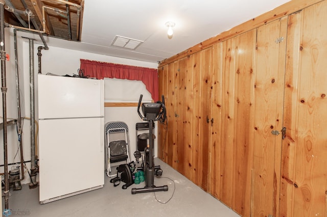 exercise area featuring wood walls