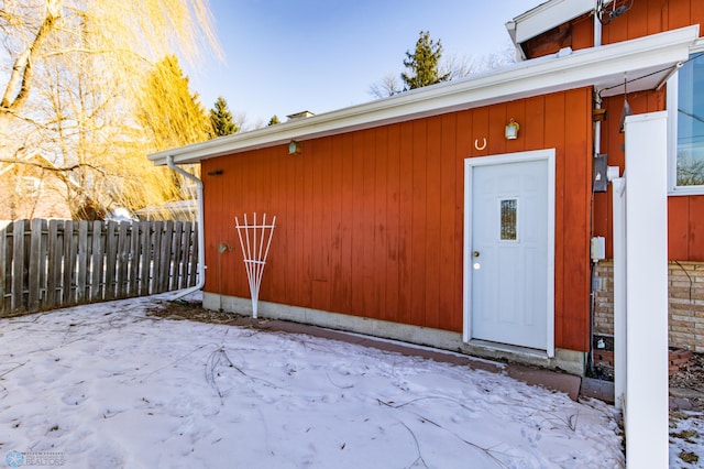 view of snow covered property entrance