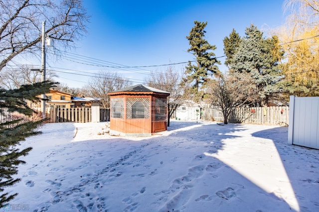 snowy yard featuring a gazebo