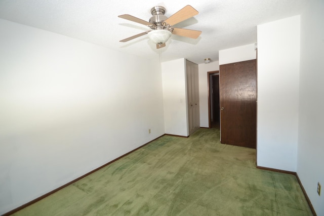 unfurnished room featuring a textured ceiling, carpet floors, and ceiling fan