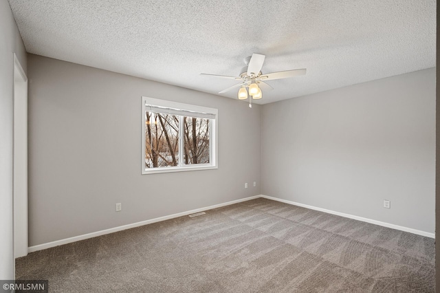 unfurnished room featuring ceiling fan, carpet floors, and a textured ceiling