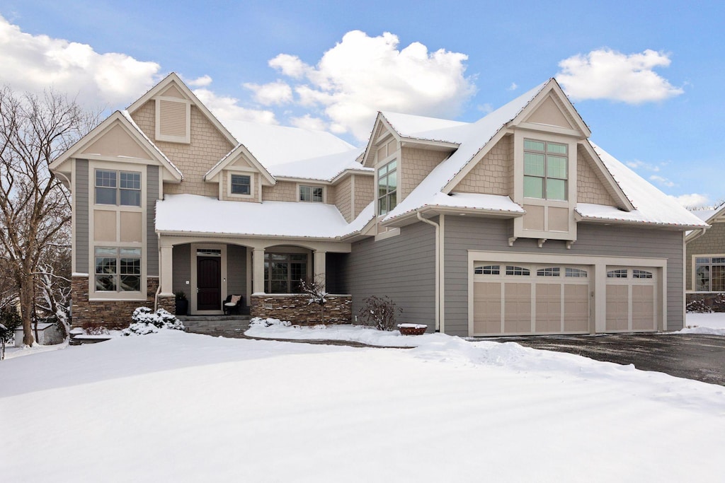 craftsman inspired home featuring a garage and covered porch