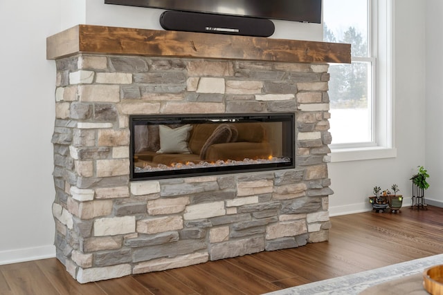 interior details featuring hardwood / wood-style flooring and a fireplace