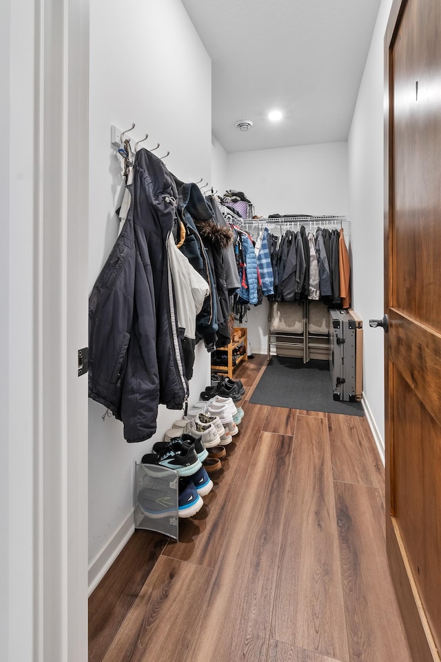 spacious closet with hardwood / wood-style flooring