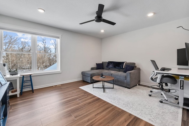 office featuring ceiling fan, wood-type flooring, and a textured ceiling