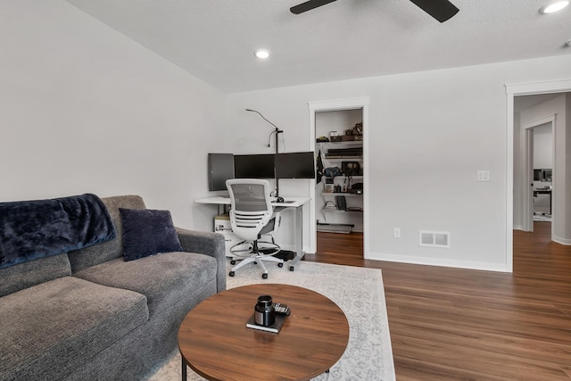 office with a textured ceiling, dark hardwood / wood-style floors, and ceiling fan