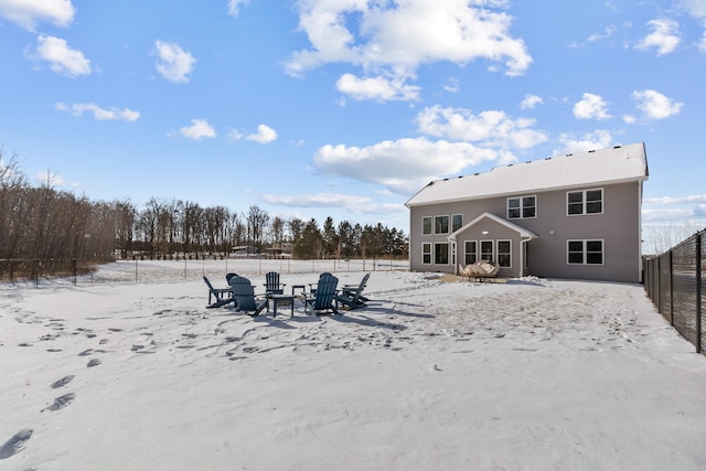 view of snow covered rear of property