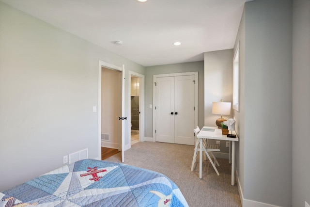 carpeted bedroom with a closet