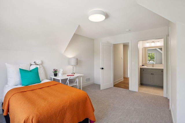 carpeted bedroom with ensuite bath