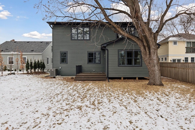 snow covered property featuring central AC