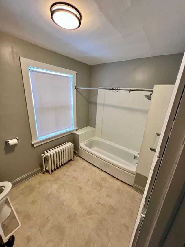 bathroom featuring radiator heating unit, toilet, and  shower combination