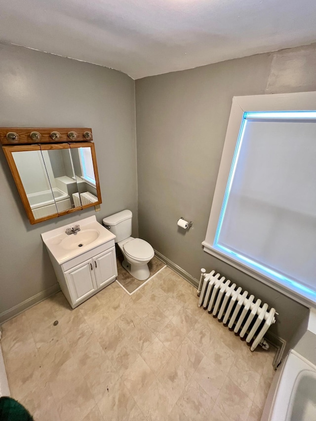 bathroom featuring vanity, radiator, and toilet