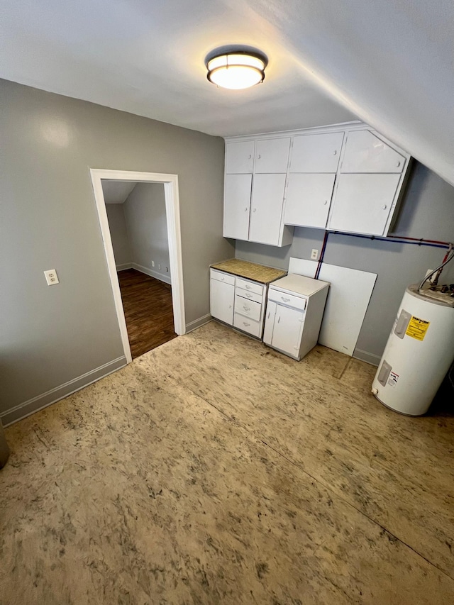 kitchen featuring white cabinetry and water heater