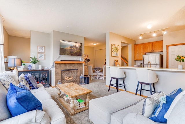 14587 Olivine Way NW, Ramsey, MN 55303 - living room featuring light colored carpet and a tiled fireplace