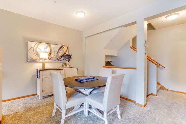 14587 Olivine Way NW, Ramsey, MN 55303 - dining space featuring light carpet, baseboards, and stairs