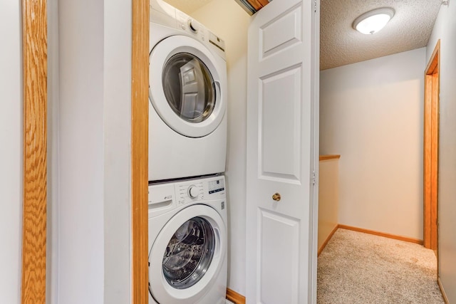 14587 Olivine Way NW, Ramsey, MN 55303 - washroom featuring stacked washer / drying machine, carpet flooring, a textured ceiling, and baseboards