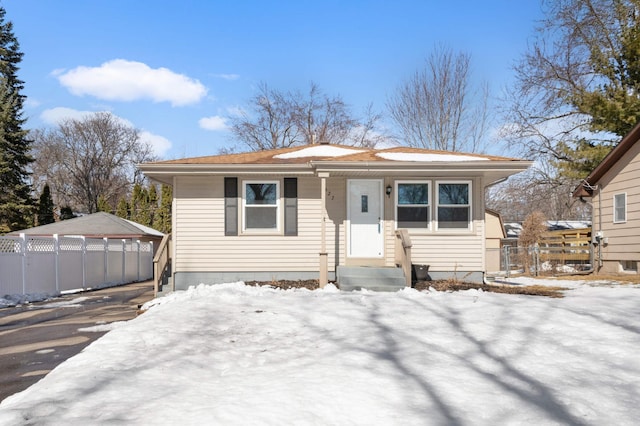 bungalow-style home with fence